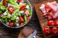 Salad. Fresh summer lettuce salad.Healthy mediterranean salad olives tomatoes parmesan cheese and prosciutto Royalty Free Stock Photo