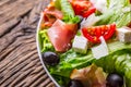 Salad. Fresh summer lettuce salad.Healthy mediterranean salad olives tomatoes parmesan cheese and prosciutto Royalty Free Stock Photo