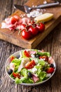 Salad. Fresh summer lettuce salad.Healthy mediterranean salad olives tomatoes parmesan cheese and prosciutto Royalty Free Stock Photo