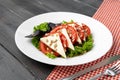 Salad with fresh tomatoes and brined cheese, sunflower seeds on top