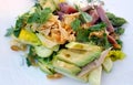 Salad with fresh tuna slices, avocado, herbs and cucumber closeup
