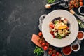 Salad of fresh vegetables with blue cheese and parmesan cheese. On the old background. Free copy space. Royalty Free Stock Photo