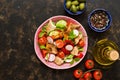 Salad of fresh vegetables with bread fattoush closeup. Arabic dish fattoush on a dark background, top view. Royalty Free Stock Photo