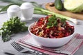 Salad from fresh vegetables: cabbage, beet, carrot, cucumber, onion and parsley in white bowl on gray background, Closeup.