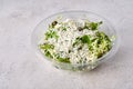 Salad of fresh vegetables with cheese in transparent plastic container Royalty Free Stock Photo