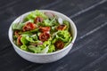 Salad with fresh vegetables, garden herbs and sun-dried tomatoes in a white bowl Royalty Free Stock Photo