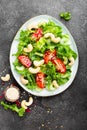 Salad with fresh vegetables and nuts. Vegetable salad with fresh vegetables and cashew. Vegetable salad on plate Royalty Free Stock Photo