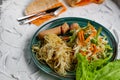 Salad of fresh vegetables on a plate with leaves, next to toasted pasta spaghetti with egg and meat sausage, a Hearty lunch, every Royalty Free Stock Photo