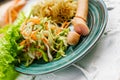 Salad of fresh vegetables on a plate with leaves, next to toasted pasta spaghetti with egg and meat sausage, a Hearty lunch, every Royalty Free Stock Photo