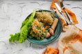 Salad of fresh vegetables on a plate with leaves, next to toasted pasta spaghetti with egg and meat sausage, a Hearty lunch, every Royalty Free Stock Photo