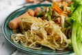 Salad of fresh vegetables on a plate with leaves, next to toasted pasta spaghetti with egg and meat sausage, a Hearty lunch, every Royalty Free Stock Photo