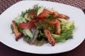 Salad of fried julienne slices of meat and fresh vegetables