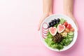 Salad with fruits and vegetables on plate holding by hand Royalty Free Stock Photo