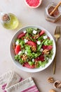 Salad with grapefruit, white cheese, pomegranate and nuts. Healthy eating. Vegetarian food. Diet