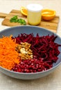 Salad of grated red beets carrots pomegranates and walnuts Royalty Free Stock Photo