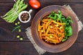 Salad from green beans, stewed with onions in tomato sauce and green leaves of arugula