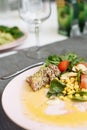 Salad of greens, canned corn and fried tuna in sesame seeds. Recipe for an expensive fish Royalty Free Stock Photo