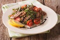 Salad with grilled beef, arugula, tomatoes and balsamic vinegar