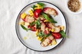 Salad with grilled peaches, corn, fresh tomatoes and basil