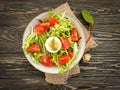 salad with herbs tomatoes on a wooden background organic dinner