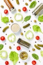 Salad ingredients layout on white desk. Food pattern with cherry tomatoes, cucumbers, greens, pepper and spices