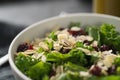 Salad with kale, cranberries and almond flakes in white bowl closeup Royalty Free Stock Photo