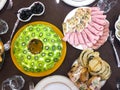 Salad with kiwi, ham, pieces of stuffed turkey, rolls with salmon at a Christmas dinner