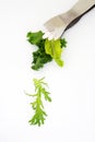 Salad leaves falling from silver tongs