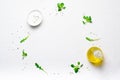 Salad Leaves, Olive Oil, Yogurt Dressing and Sesame Seeds on Bright Background