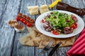 Salad leaves with sliced roast beef and sun-dried cherry tomatoes on wooden background Royalty Free Stock Photo