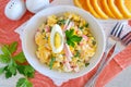 Salad made of orange, crab meat, eggs, corn served with yogurt in a white bowl on a cloth background. Simple food Royalty Free Stock Photo