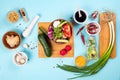 Salad making. Cutlery and dressing ingredients for fresh salad on light blue background, top view Royalty Free Stock Photo