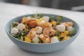 Salad with mango, mozzarella, shrimps and mixed microgreens in blue bowl on white oak table Royalty Free Stock Photo