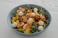 Salad with mango, mozzarella, shrimps and mixed microgreens in blue bowl on white oak table Royalty Free Stock Photo