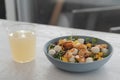 Salad with mango, mozzarella, shrimps and mixed microgreens in blue bowl on white oak table Royalty Free Stock Photo