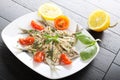 Salad marinated sardines with basil and tomato