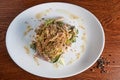 Salad of meat, lettuce, pickled cucumbers, parsley, walnuts, next to a mixture of black, white, green and Brazilian pepper