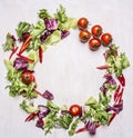 Salad mix with cherry tomatoes, laid out in the frame place for text wooden rustic background top view