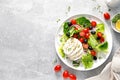 Salad with mozzarella cheese, cherry tomato, olives and romain lettuce, top view