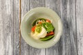 Salad mozzarella with vegetables in plate on wooden background. Top view