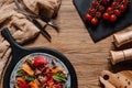 Salad with mussels, vegetables and jamon, fork with knife and fresh tomatoes Royalty Free Stock Photo