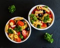 Salad: pasta fusilli, black and green olives, cherry tomatoes, red onion and parsley Royalty Free Stock Photo