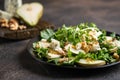 Salad of pear, blue cheese, arugula and nuts with spicy dressing