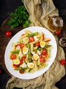 Salad - penne pasta with asparagus, tomatoes, quail eggs, mozzarella Royalty Free Stock Photo