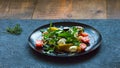 Salad on a plate: arugula, cherry tomatoes, figs, grated cheese, black grapes Royalty Free Stock Photo