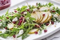 Healthy dandelion salad with pear fruit, pomegranate and fresh cheese