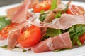 Salad with prosciutto arugula and tomatoes