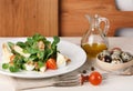 Salad with quail egg, cherry tomato, crackers and corn salad on white and wooden background Royalty Free Stock Photo