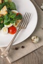 Salad with quail egg, cherry tomato, crackers and corn salad on wooden background Royalty Free Stock Photo