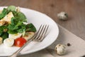 Salad with quail egg, cherry tomato, crackers and corn salad on wooden background Royalty Free Stock Photo